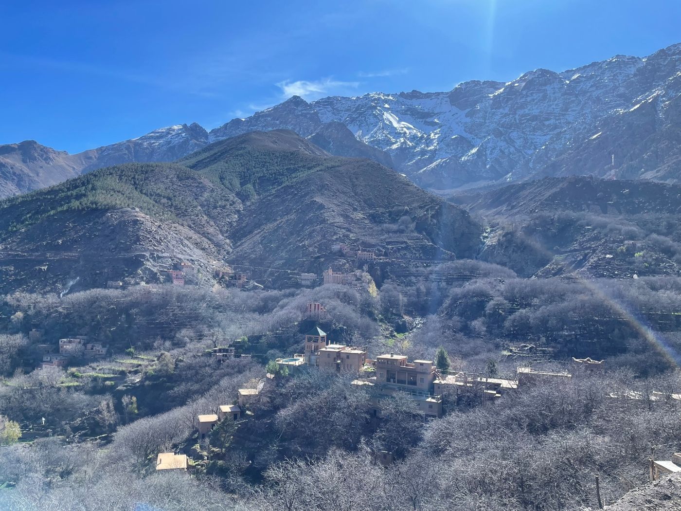 A collection of buildings nestled in the snow-capped peaks of the High Atlas Mountains near Imlil, Morocco.