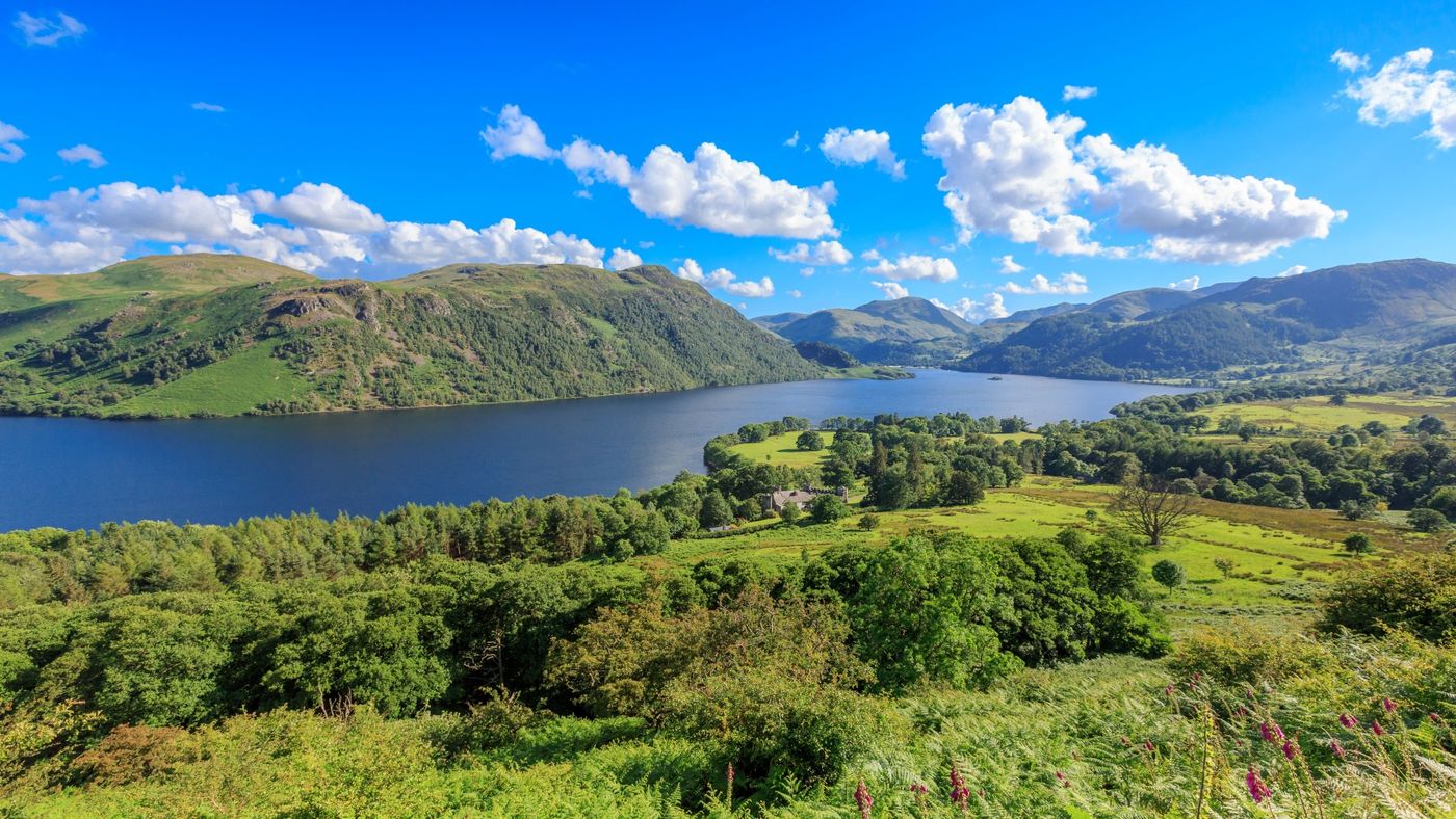 High-angle panorama of the deep blue waters of Ullswater Lake