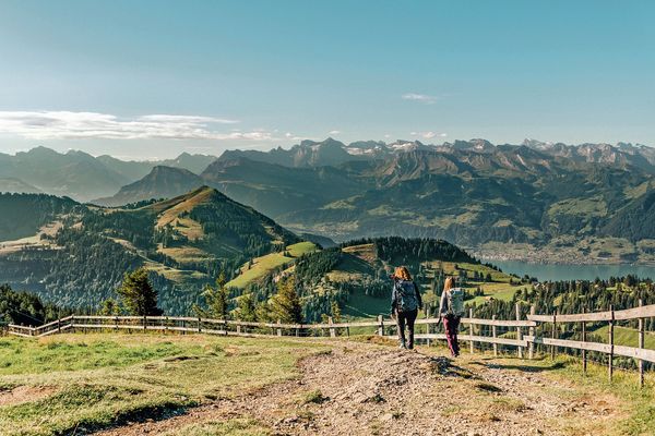 Hikers walking along Mount Rigi, looking out Lake Lucerne, and the rugged peaks of Central Switzerland-supplied by Eurortrek