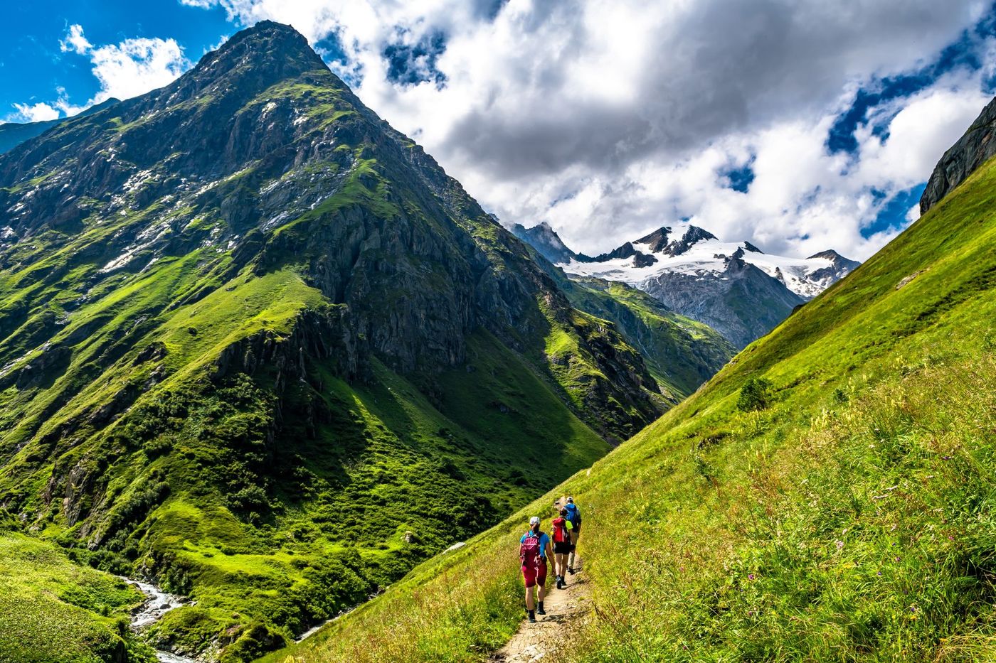 Hiking Group In Valley Of Umbalfaelle On Grossvenediger With View To Mountain Roetspitze In Nationalpark Hohe Tauern In Tirol In Austria